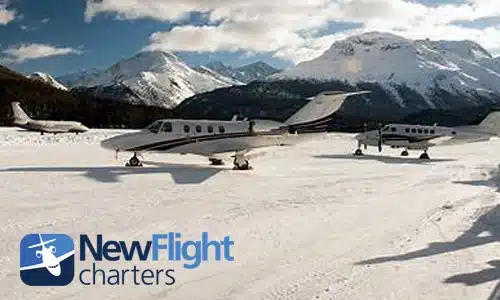 Private jet flying over Colorado mountains during winter travel planning